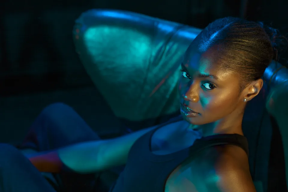 Cinematic close portrait illuminated with teal and amber light